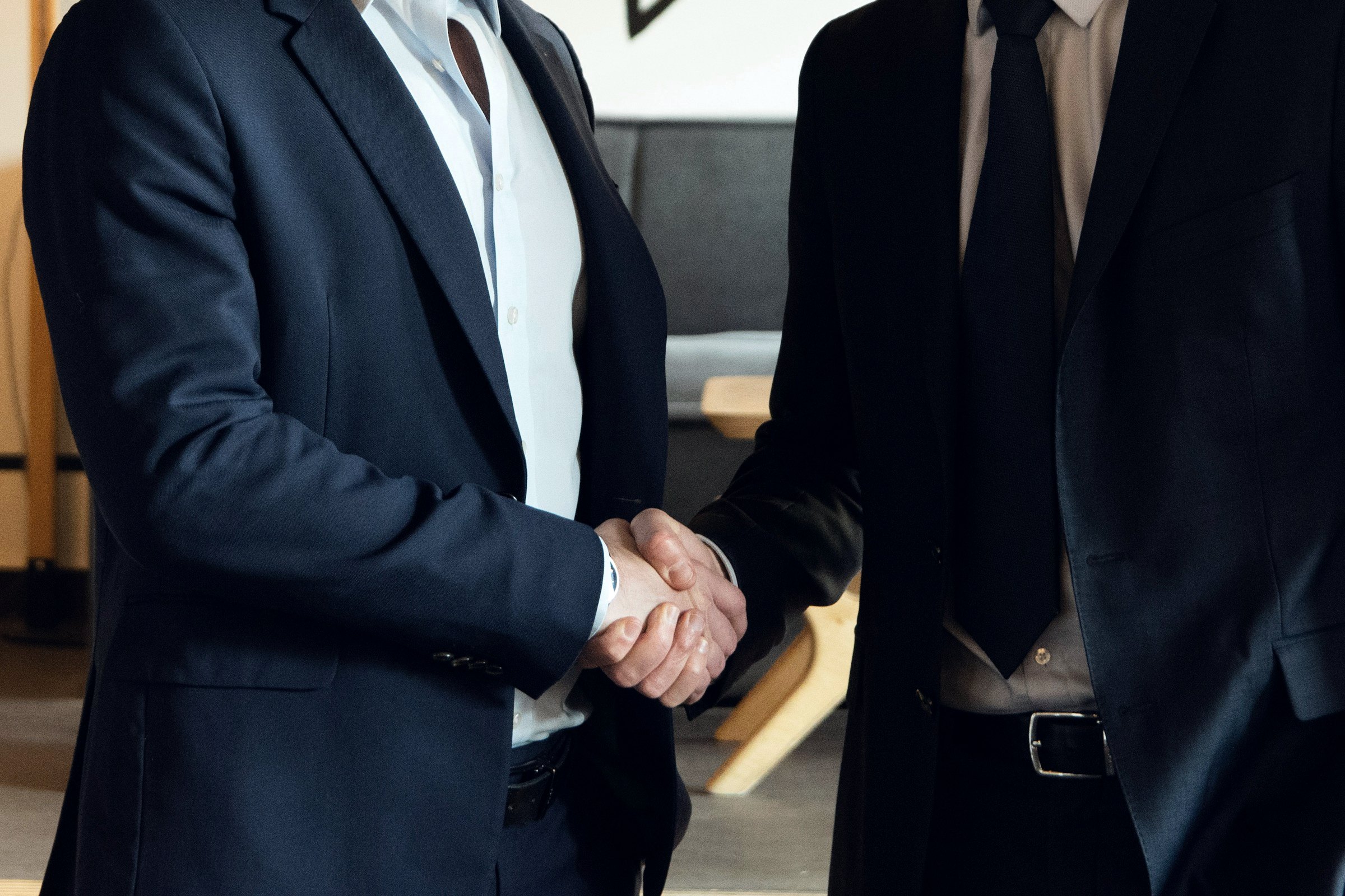 Two people in suits shaking hands
