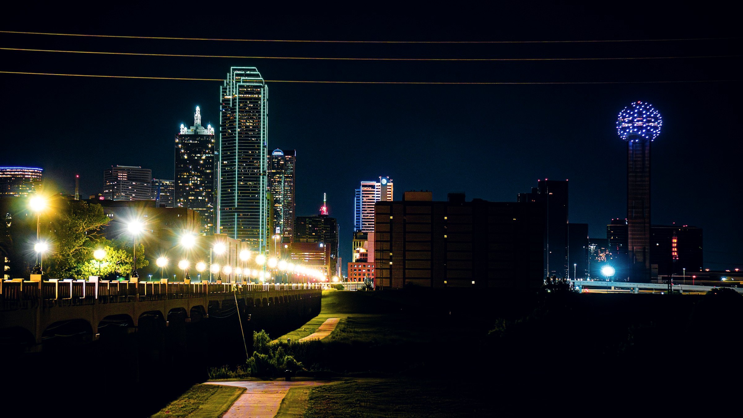 Dallas skyline at night from a lit trail